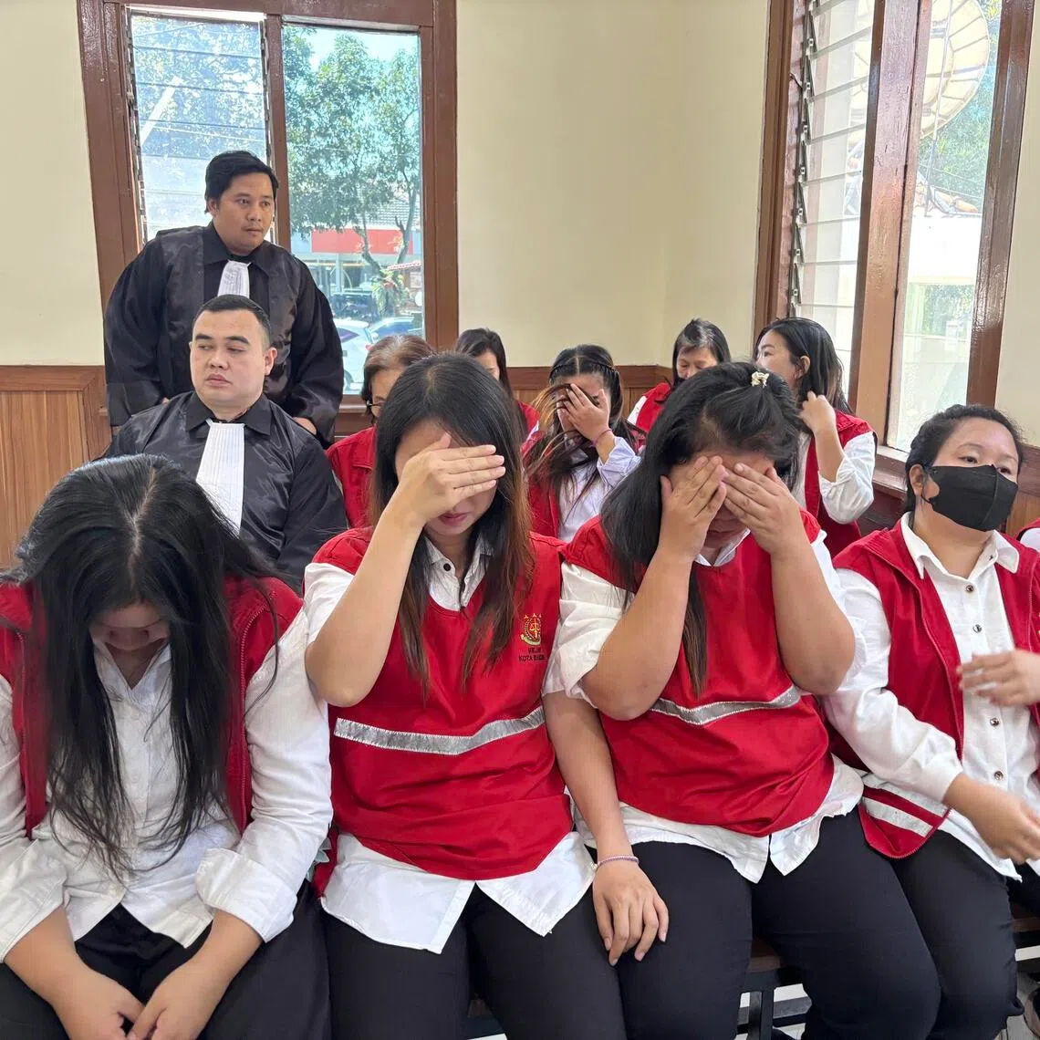 Alleged baby trafficking syndicate members await to hear prosecutors’ demands at a hearing in Bandung, West Java, on June 30.