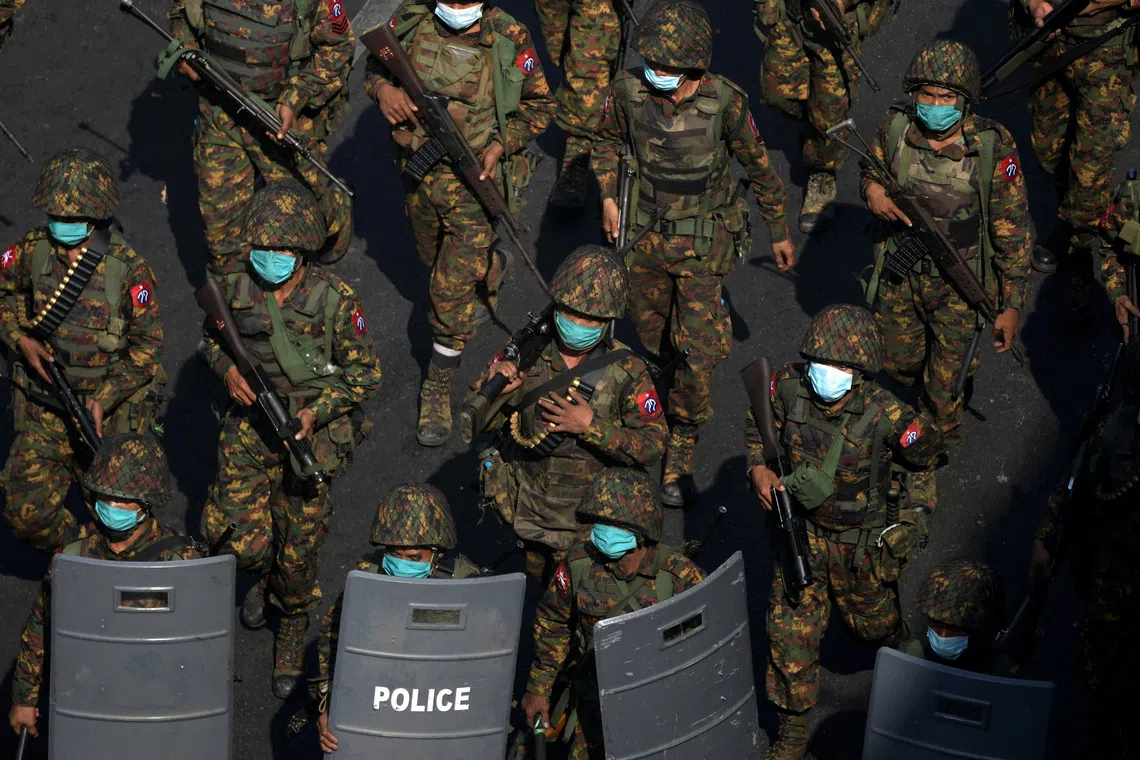 FILE PHOTO: Myanmar soldiers from the 77th light infantry division walk along a street during a protest against the military coup in Yangon, Myanmar, February 28, 2021.  Picture taken February 28, 2021. REUTERS/Stringer/File Photo