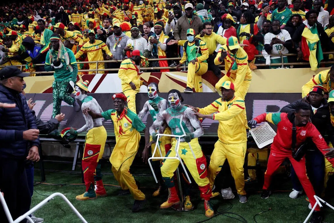 Senegal fans clash with security as fans invade the pitch after Morocco were awarded a penalty following a VAR review in the Africa Cup of Nations final.