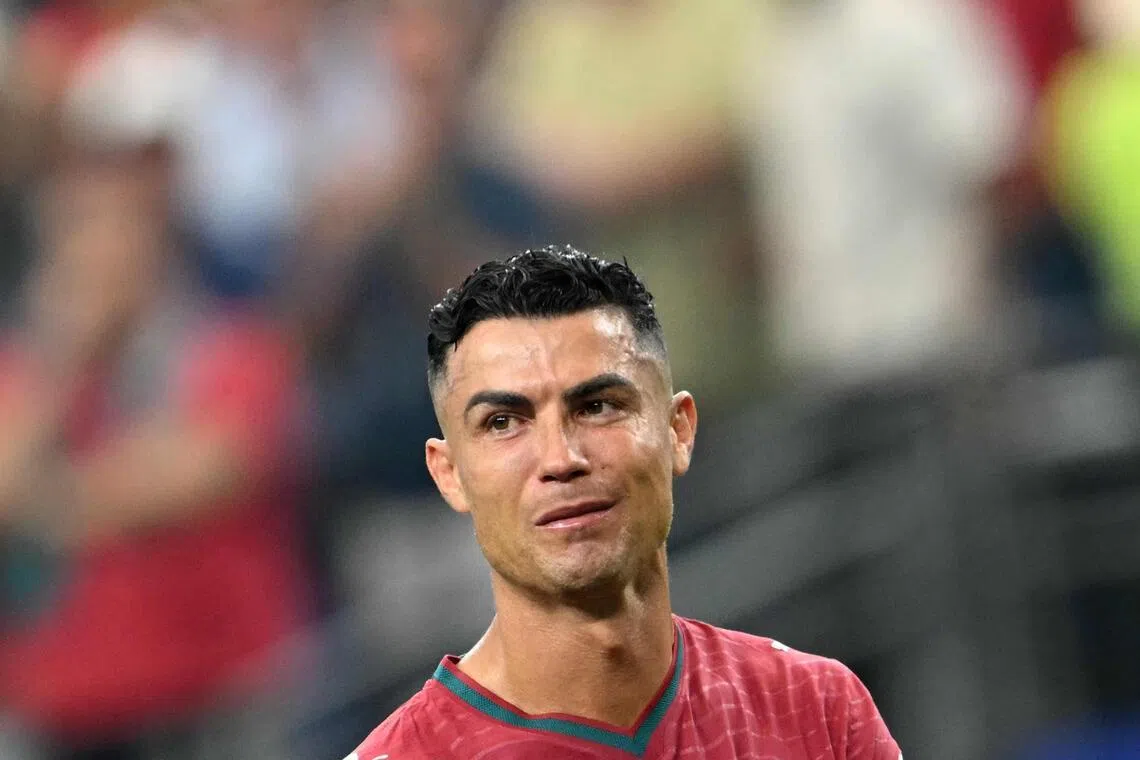 TOPSHOT - Portugal's forward #07 Cristiano Ronaldo reacts after losing the 2026 World Cup round of 16 football match between Portugal and Spain at the Dallas Stadium in Arlington on July 6, 2026. (Photo by RONALDO SCHEMIDT / AFP)