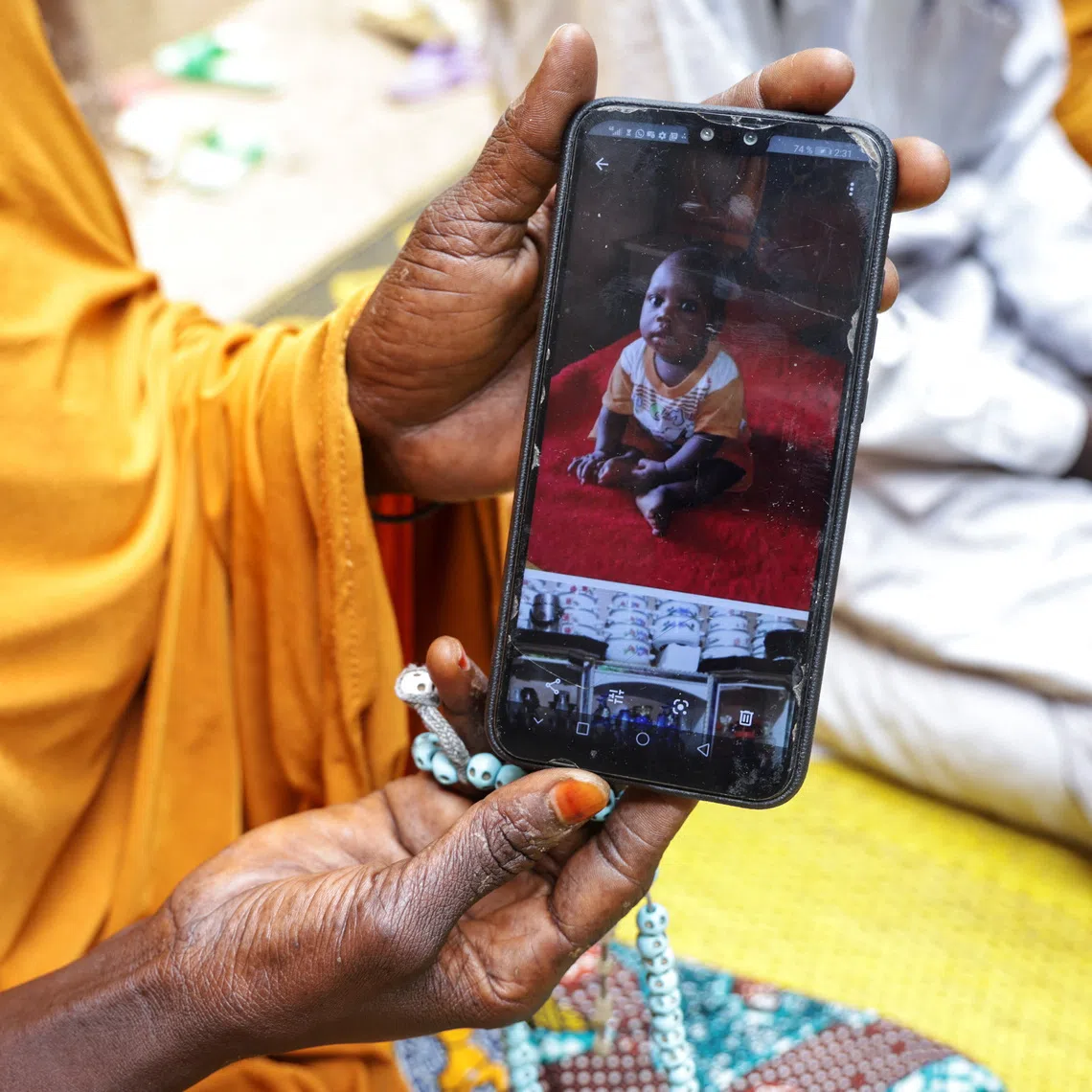 Fatimata Madou, shows a photo of Mohamat, her nine-month old child who died of malaria, in Bogo, Cameroon September 4, 2025. REUTERS/Desire Danga Essigue