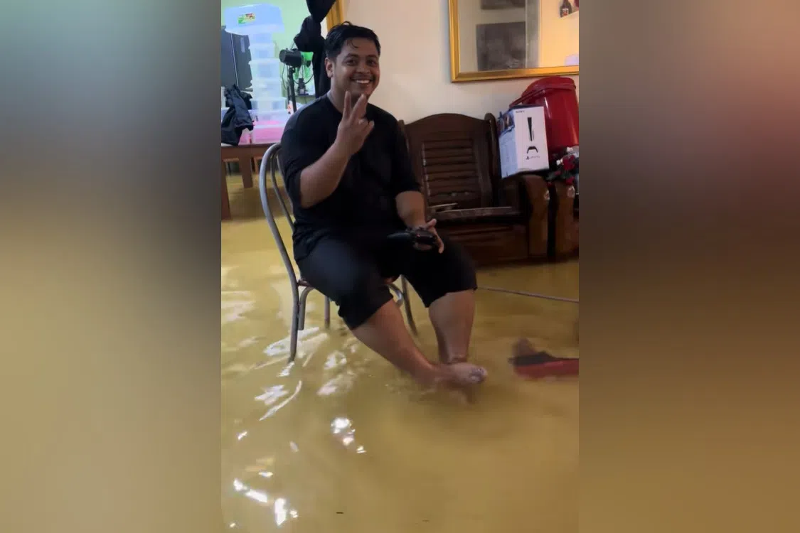 The 11-sec clip showed a man sitting on a chair and surrounded by ankle-deep murky water. 