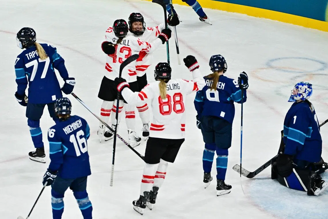 Milano Cortina 2026 Olympics - Ice Hockey - Women's Preliminary Round - Group A - Finland vs Canada - Milano Rho Ice Hockey Arena, Milan, Italy - February 12, 2026. Jennifer Gardiner of Canada celebrates scoring their first goal with Kristin O'Neill of Canada and Julia Gosling of Canada REUTERS/Marton Monus