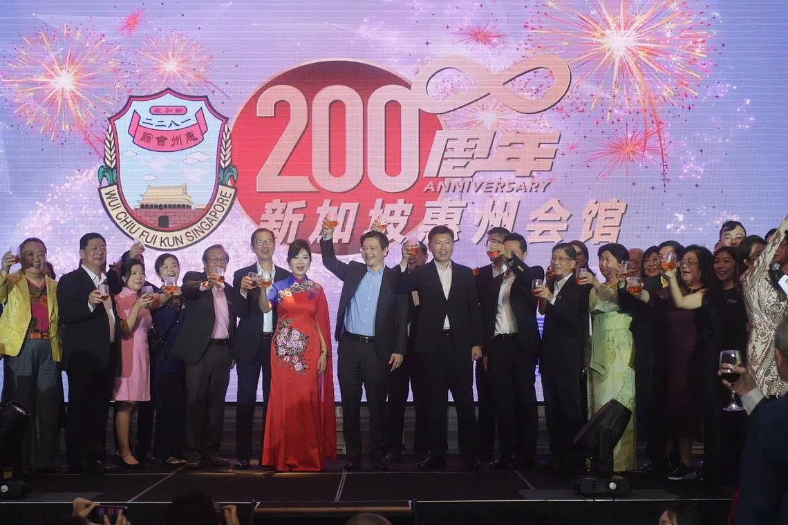Wui Chiu Fui Kun Singapore president Terene Seow (in red) and DPM Lawrence Wong at the 200th anniversary celebrations of the clan association, on Dec 8, 2022.