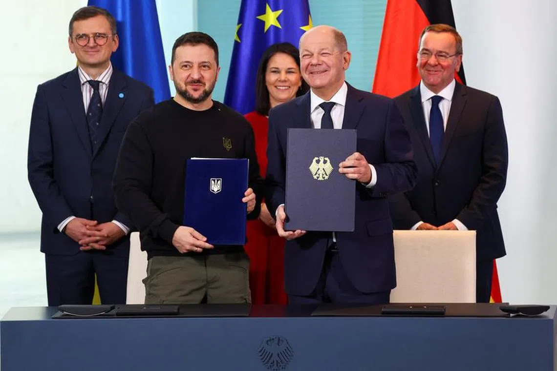German Chancellor Olaf Scholz, German Foreign Minister Annalena Baerbock, German Defence Minister Boris Pistorius, Ukrainian Foreign Minister Dmytro Kuleba and Ukraine's President Volodymyr Zelenskiy attend the signing of a bilateral agreement on security assurances and long-term support in Berlin, Germany, February 16, 2024. REUTERS/Fabrizio Bensch