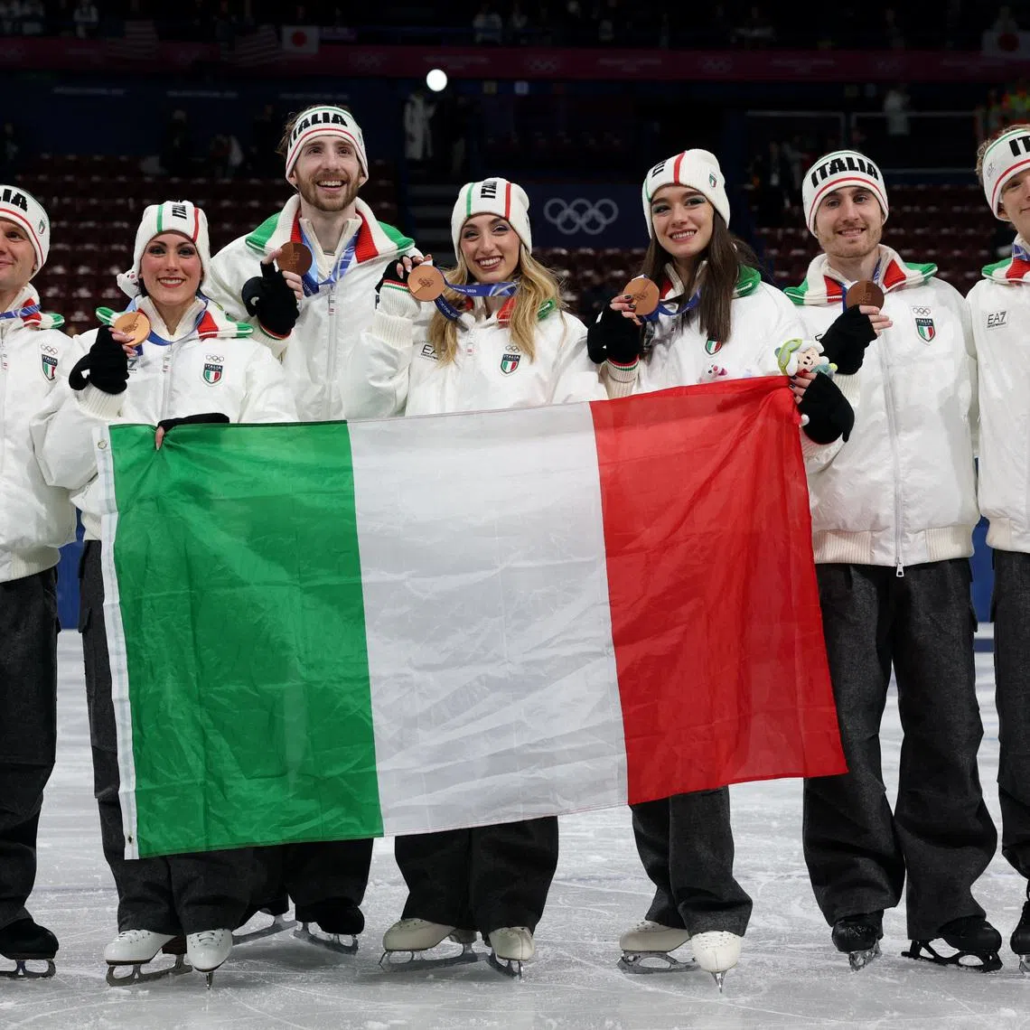 Milano Cortina 2026 Olympics - Figure Skating - Team Event - Victory Ceremony - Milano Ice Skating Arena, Milan, Italy - February 08, 2026. Bronze medallist's Matteo Rizzo, Lara Naki Gutmann, Sara Conti, Niccolo Macii, Daniel Grassl, Charlene Guignard and Marco Fabbri of Italy celebrate after finishing third in the Team Event REUTERS/Claudia Greco