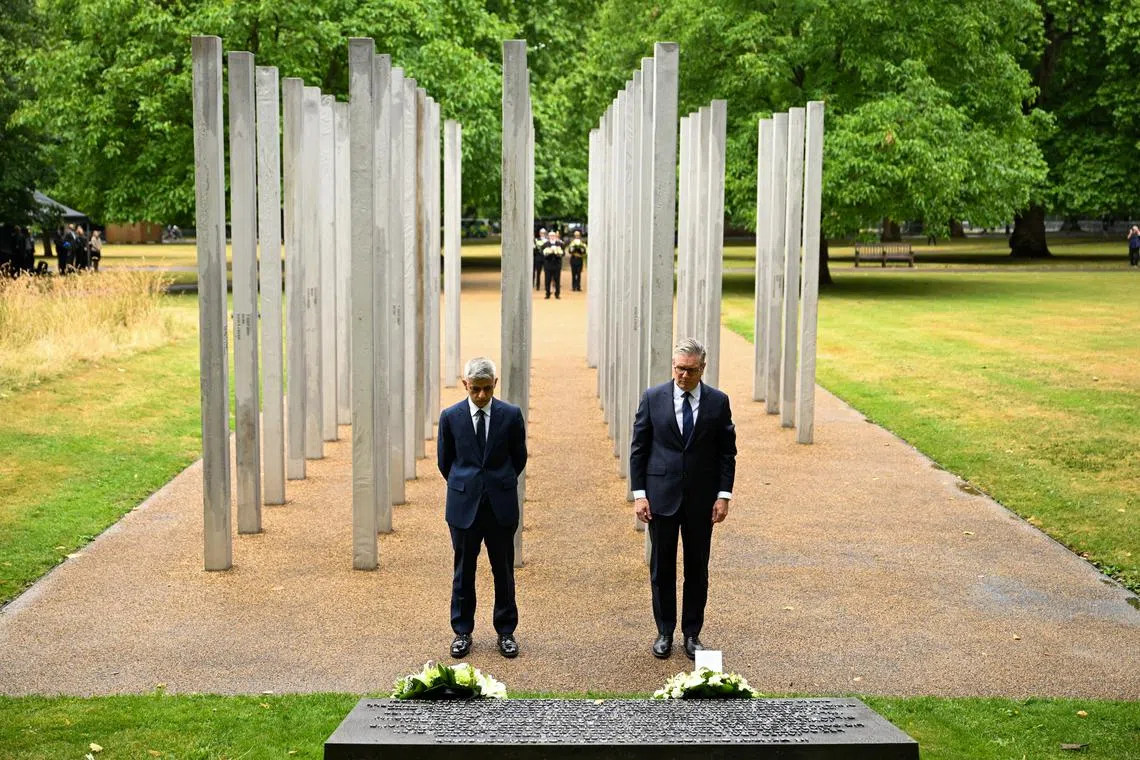 Britain's Prime Minister Keir Starmer (right) and Mayor of London Sadiq Khan lay wreaths at the 7 July Memorial Gardens on July 7.