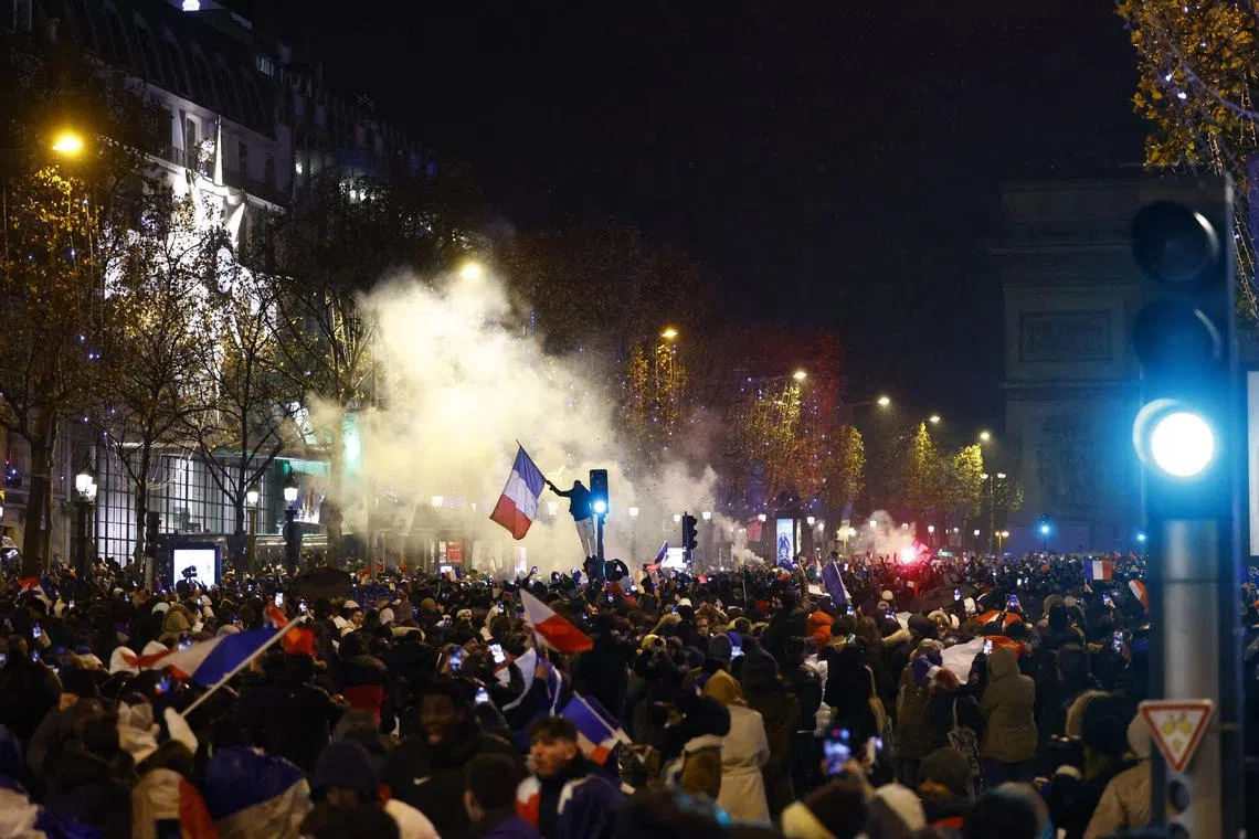 France fans react on the Champs-Elysees during the final between France and Argentina.