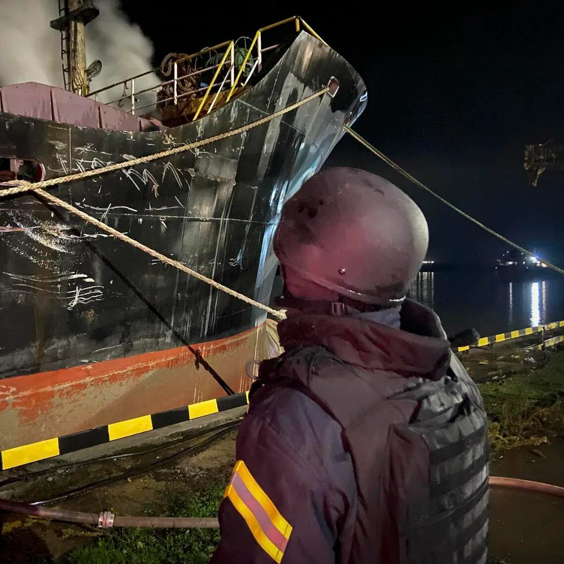 Ukrainian rescuers working at the site of a Russian strike on port facilities in Ukraine's Odesa region on Dec 23.