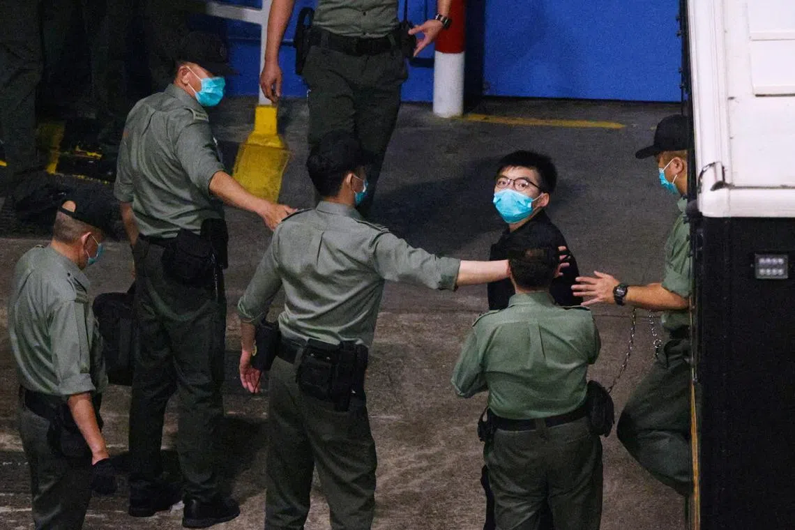 FILE PHOTO: Pro-democracy activist Joshua Wong looks on upon arriving at Lai Chi Kok Reception Centre after he remained in custody over the national security law charge, in the early morning, in Hong Kong, China March 2, 2021. REUTERS/Tyrone Siu/File Photo