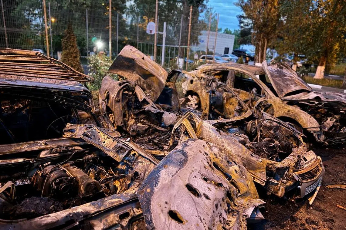 A view shows damaged vehicles at the site of a recent military strike, what local authorities called a Ukrainian air attack, in the course of the Russia-Ukraine conflict, in a location given as Belgorod, Russia, in this handout image released on May 11, 2024. Governor of Russia's Belgorod Region Vyacheslav Gladkov via Telegram/Handout via REUTERS