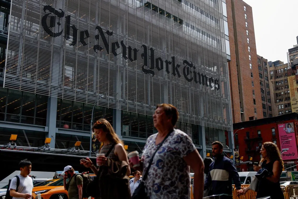 People walk by The New York Times building in Manhattan, New York City, U.S., September 16, 2025.  REUTERS/Kylie Cooper