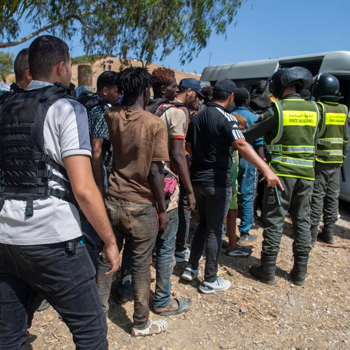 Moroccan security forces arresting migrants trying to enter the north African Spanish enclave of Ceuta on Aug 15. Hundreds of sub-Saharan African and Sudanese migrants gathered near Fnideq, Morocco, to try to enter Ceuta from Morocco.