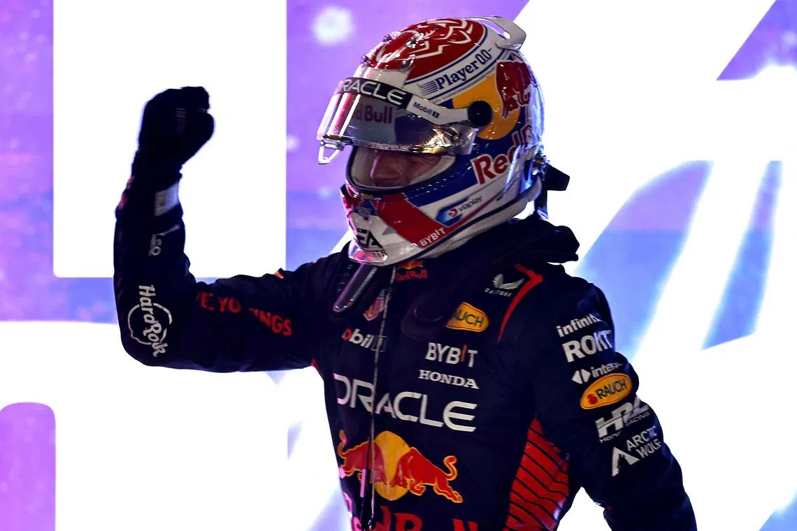 Red Bull's Max Verstappen celebrates after finishing second in the sprint race and winning the F1 championship.