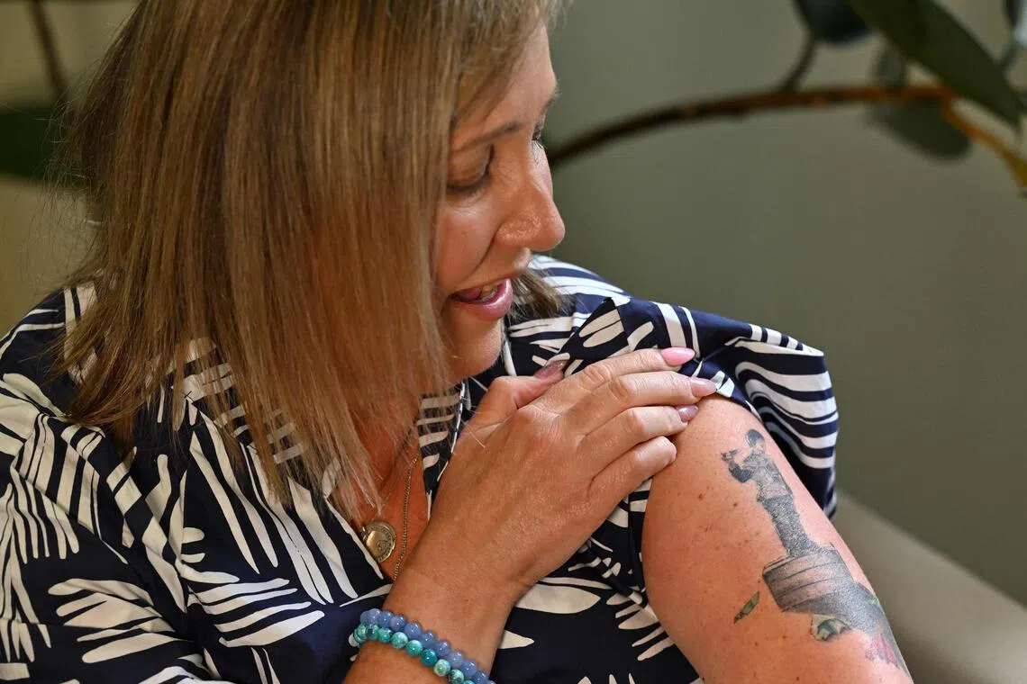 Ms Mia Bannister's skin is inked with a eulogy to her teenage son Ollie, whose suicide after a battle with anorexia and online bullying pushed her to fight for world-first laws in Australia to get kids off social media.