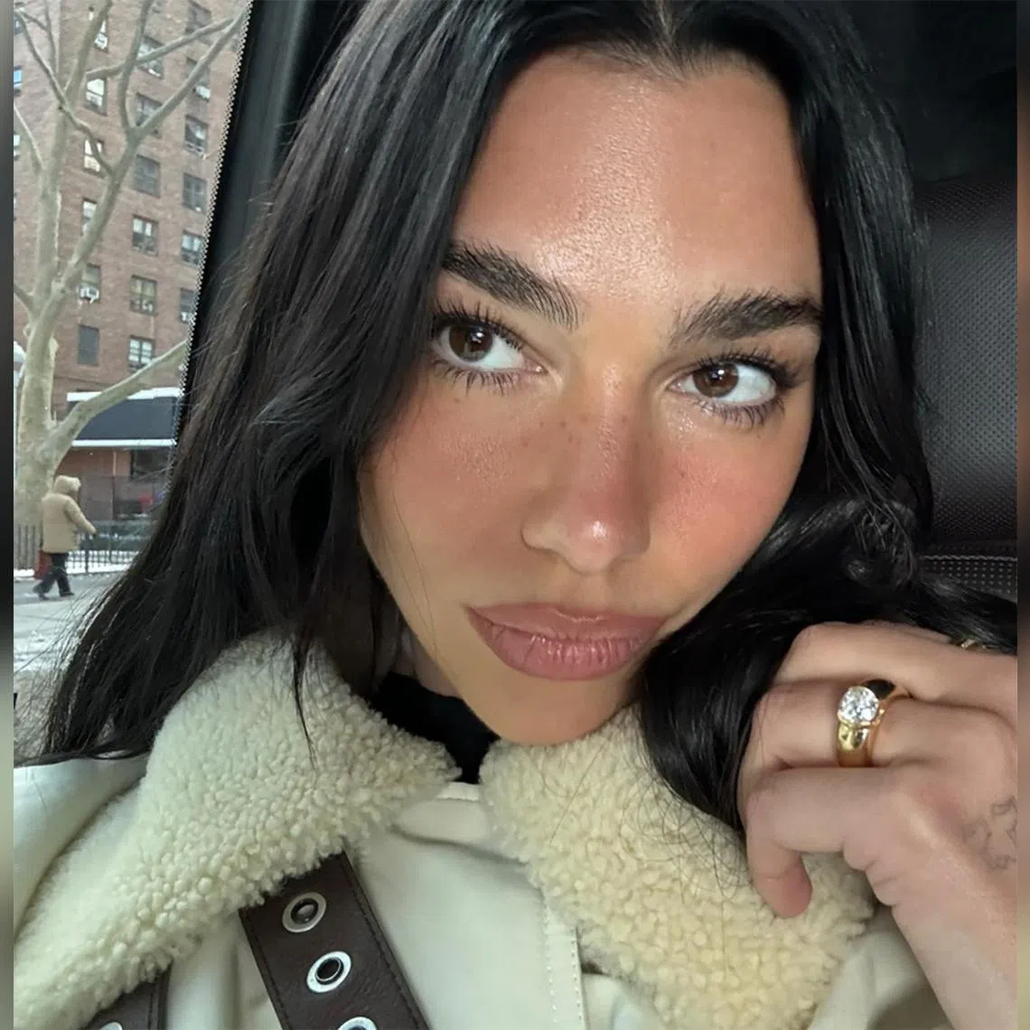 Pop star Dua Lipa sporting her chunky engagement ring.