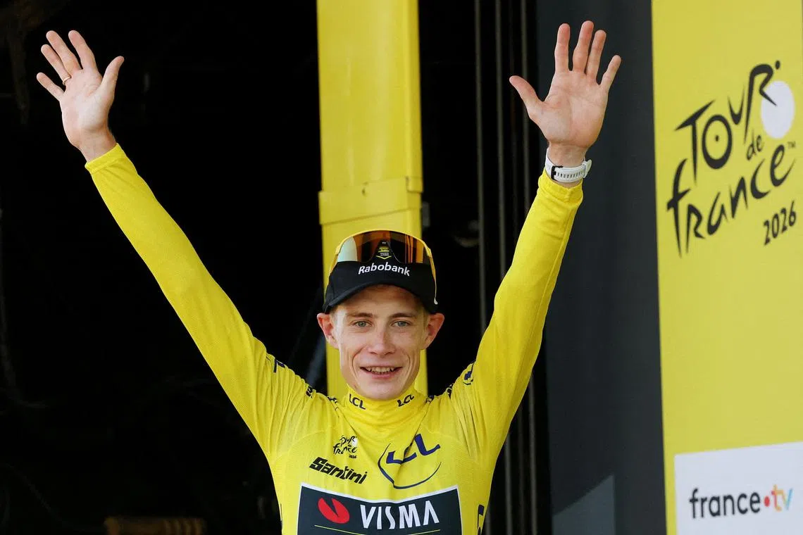 Cycling - Tour de France - Stage 1 - Barcelona to Barcelona - Barcelona, Spain - July 4, 2026 Team Visma | Lease a Bike's Jonas Vingegaard celebrates on the podium wearing the yellow jersey after stage 1 REUTERS/Gonzalo Fuentes