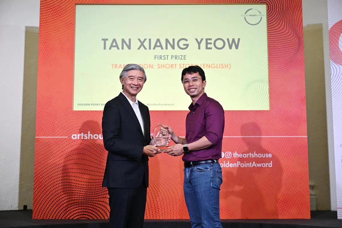 Educator Tan Xiang Yeow (right), winner of the inaugural translation category at the 2023 Golden Point Award, receiving his award at The Arts House on Dec 2.