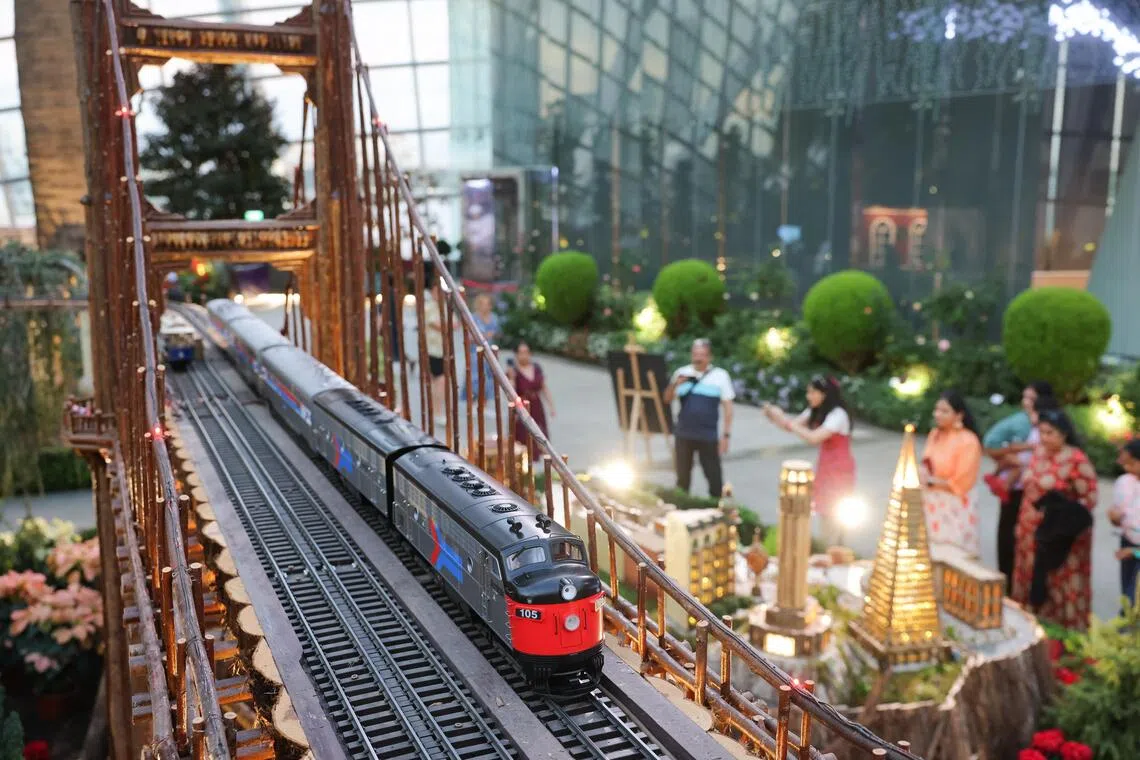 A model train travelling across a botanical model of San Francisco's Golden Gate Bridge during the preview of the Christmas Train Show at Gardens by the Bay.