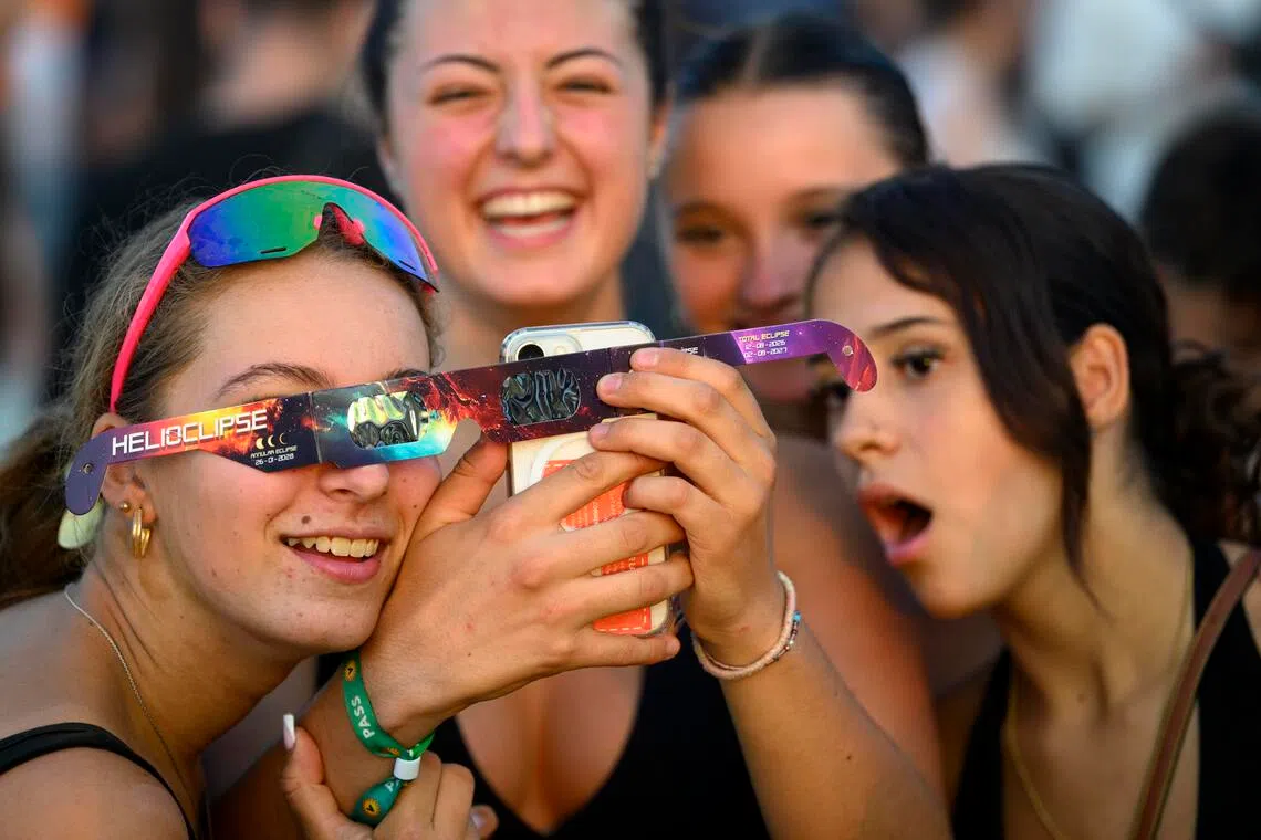 epa13164553 Festival-goers take pictures with a mobile phone and a pair of protective eclipse viewing glasses while observing the Sun during a partial solar eclipse at the 30th Venoge Festival in Penthaz, Switzerland, 12 August 2026. A total solar eclipse will sweep across parts of Europe and the North Atlantic on 12 August, with the path of totality moving through Greenland, Iceland, Spain, and a small section of northeastern Portugal, while surrounding areas across Europe experience a partial solar eclipse, according to the European Space Agency (ESA).  EPA/LAURENT GILLIERON EDITORIAL USE ONLY