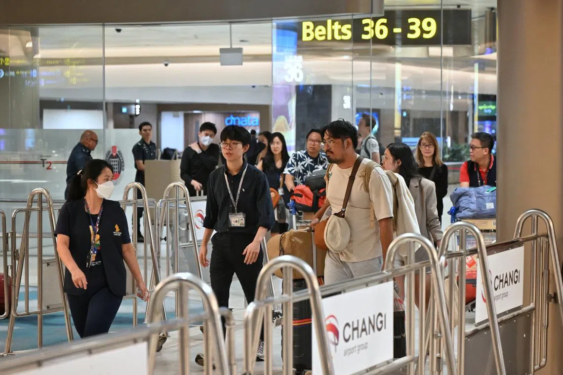 Passengers who were on board SQ321 arriving at Changi Airport on May 22 after taking a special flight from Bangkok.