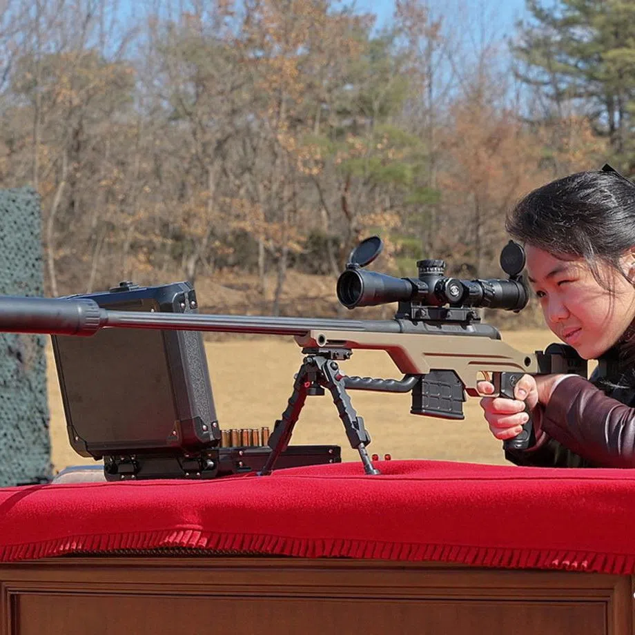 North Korean leader Kim Jong Un's daughter, Kim Ju Ae, looks through a viewfinder as she and her father meet with leading officials and military commanders in Pyongyang, North Korea, in this picture released on February 28, 2026, by North Korea's official Korean Central News Agency. KCNA via REUTERS