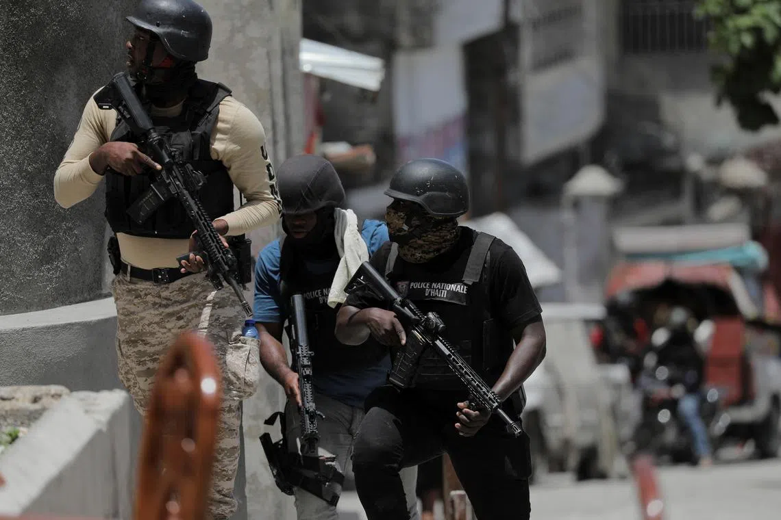 Police try to protect residents fleeing the neighbourhood after gangs took over Carrefour Feuilles, Haiti.