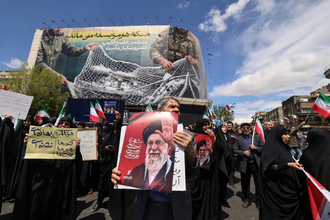 Iranians gather in Tehran's Revolution Square in memory of the country’s slain supreme leader Ali Khamenei.