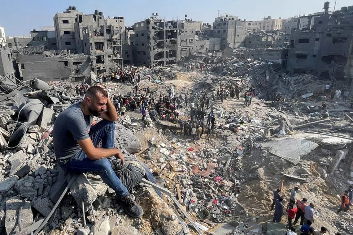 FILE PHOTO: A man gestures as Palestinians search for casualties a day after Israeli strikes on houses in Jabalia refugee camp in the northern Gaza Strip, November 1, 2023. REUTERS/Mohammed Al-Masri/File photo