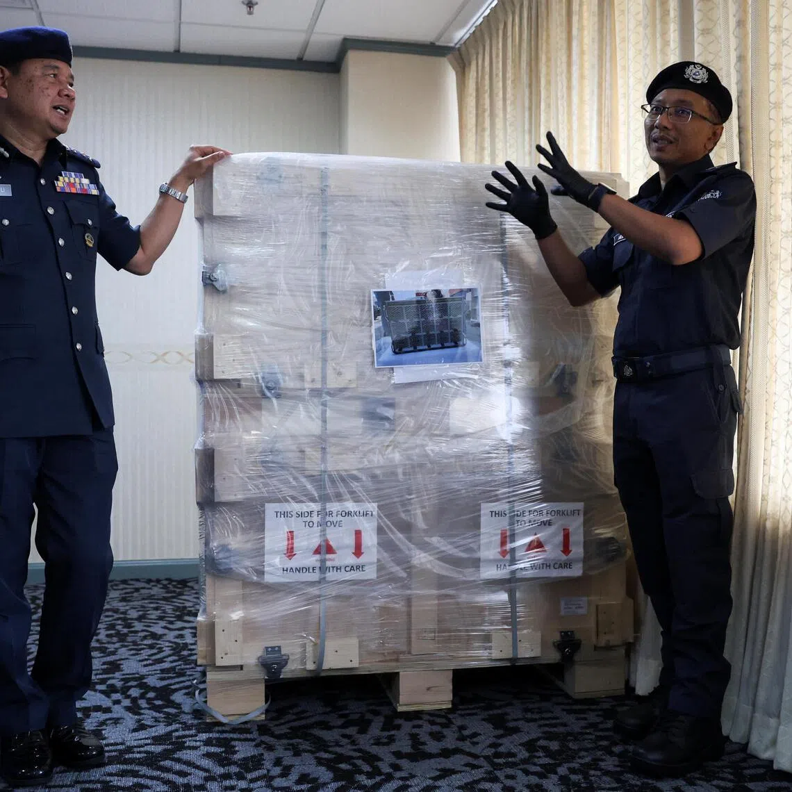Malaysia’s customs department officers show a pallet of server units containing advanced AI chips during a press conference on the department’s seizure of 72 server units on June 26.