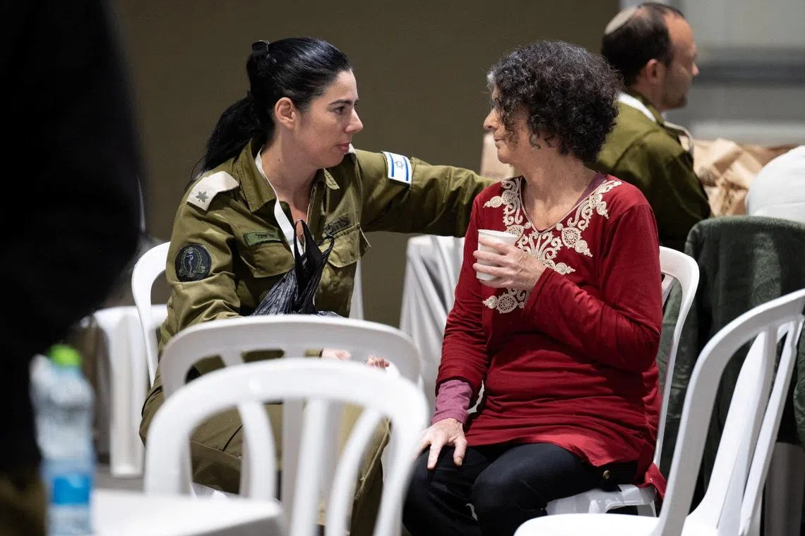 Shoshan Haran, a released Israeli hostage, speaks with an Israeli soldier shortly after her arrival in Israel on November 25, after being held hostage by the Palestinian militant group Hamas in the Gaza Strip, at an unknown location in Israel, in this handout picture released by the Israeli Prime Minister's Office on November 26, 2023. Israeli Prime Minister's Office/Handout via REUTERS/File photo