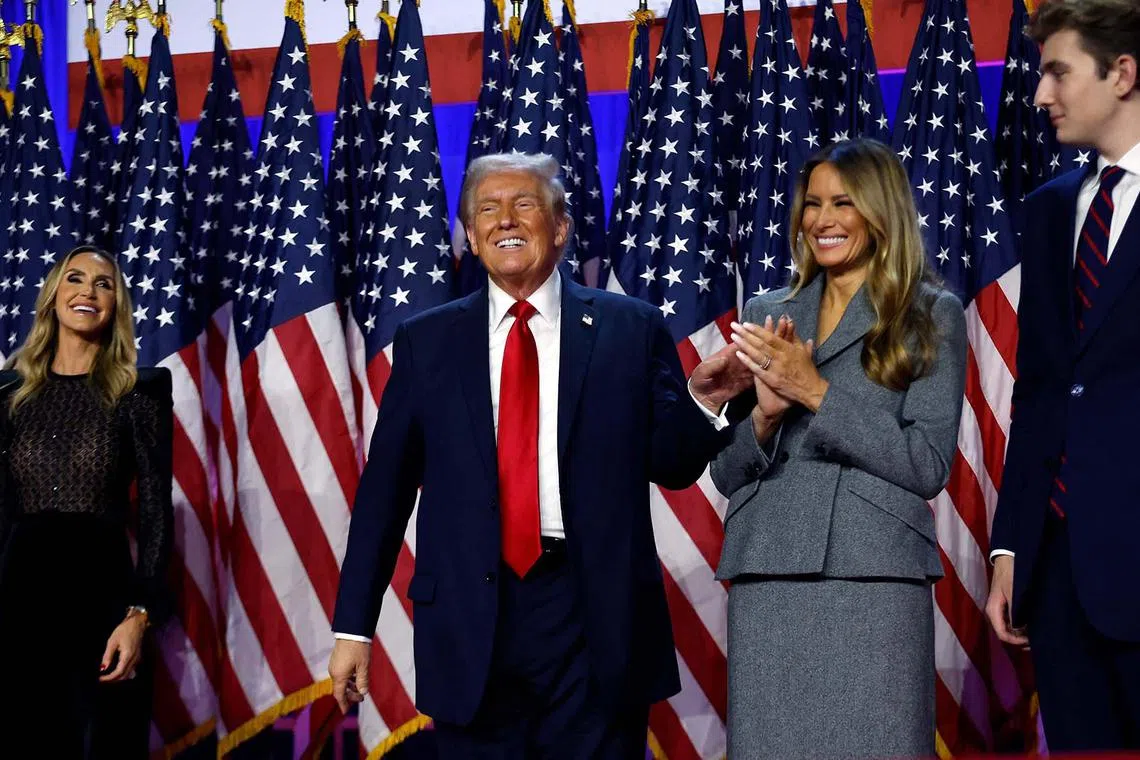 Republican presidential nominee and former US President Donald Trump reacting on stage with former first lady Melania Trump during an election night event at the Palm Beach Convention Centre on Nov 06, 2024 in West Palm Beach, Florida.
