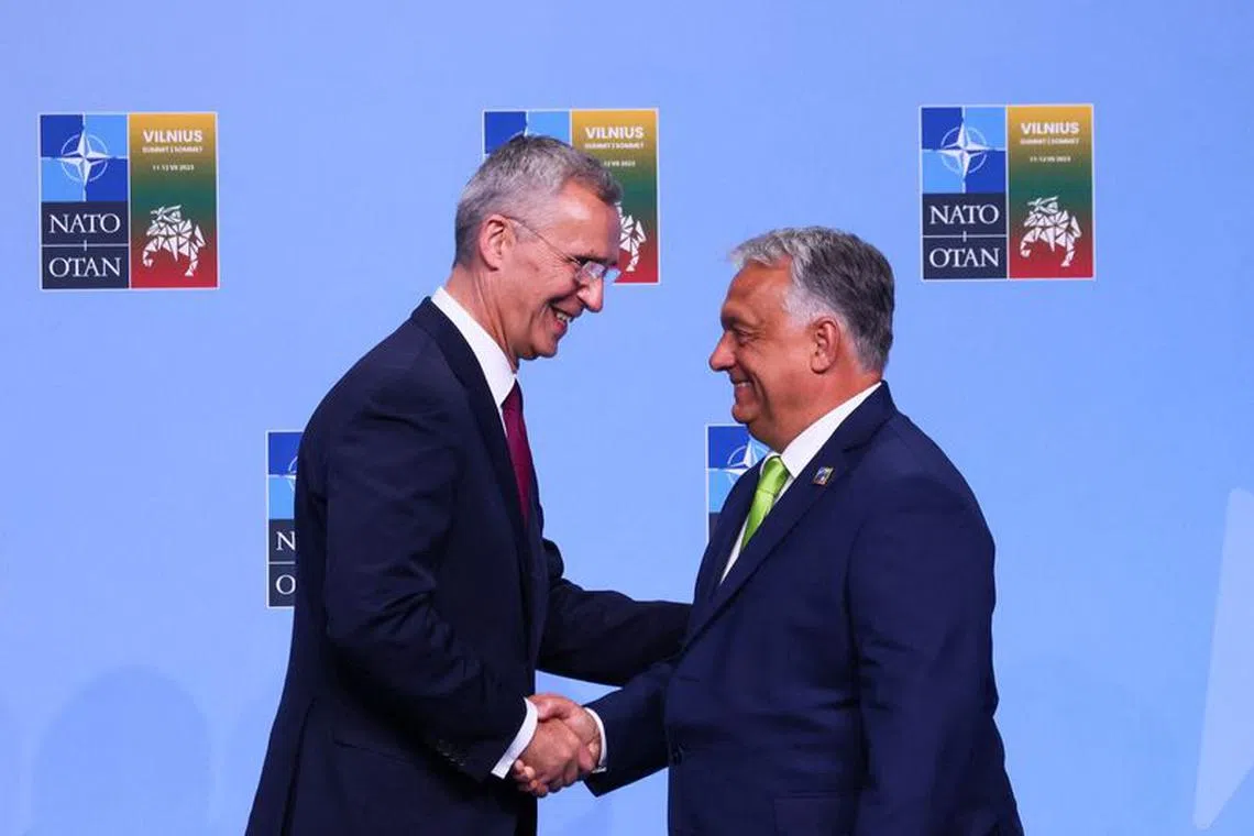 NATO Secretary-General Jens Stoltenbergm shakes hands with Hungarian Prime Minister Viktor Orban, ahead of a NATO leaders summit in Vilnius, Lithuania July 11, 2023. REUTERS/Yves Herman/File Photo