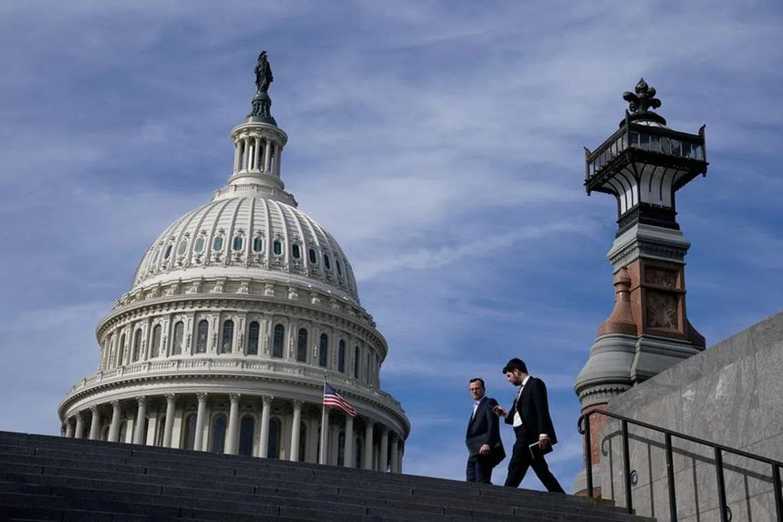 People walk past the U.S. Capitol building in Washington, U.S., November 15, 2023. REUTERS/Elizabeth Frantz/File Photo