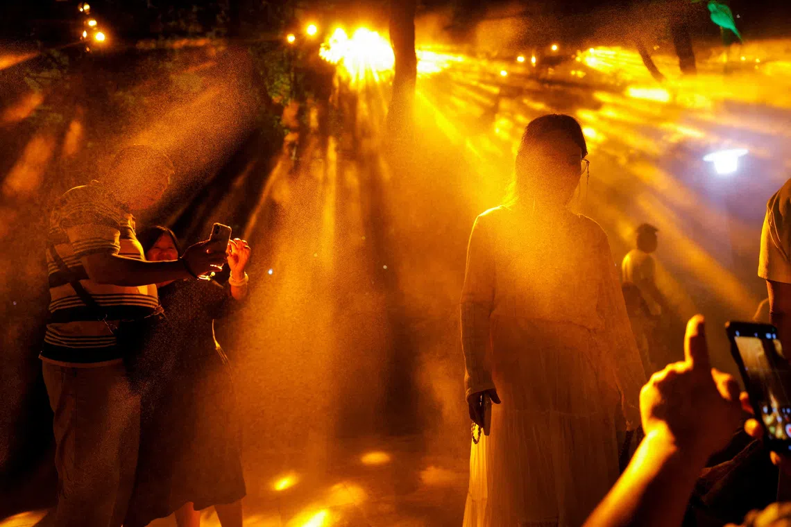 People take pictures at a light installation during the Shanghai International Light Festival in Shanghai, China, September 28, 2026. REUTERS/Go Nakamura TPX IMAGES OF THE DAY