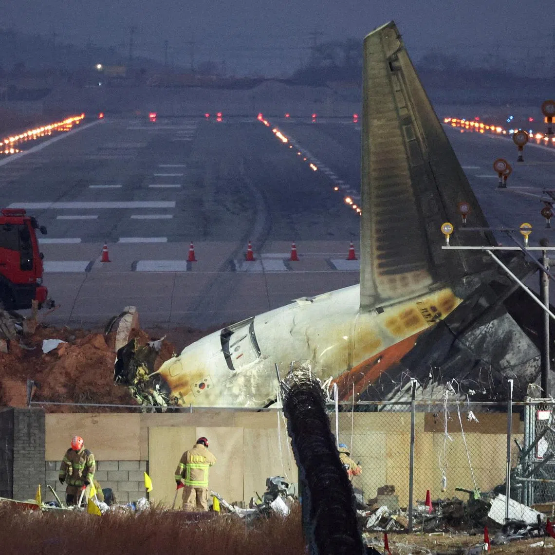 Rescuers work near the wreckage of the Jeju Air aircraft that went off the runway and crashed at Muan International Airport, in Muan, South Korea, December 30, 2024.