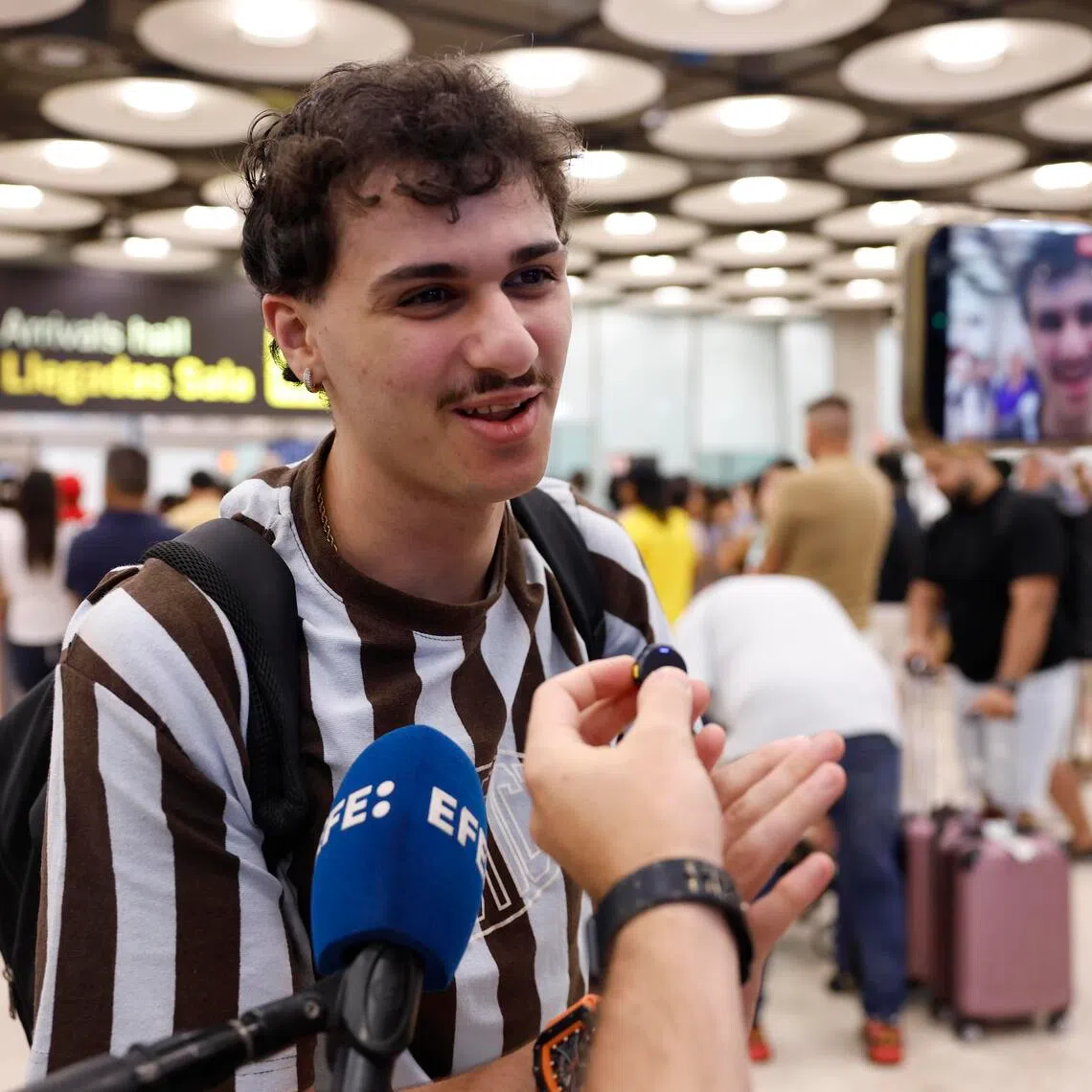 A passenger speaking to members of the media upon his arrival from Italy, at Adolfo Suarez Barajas Airport in Madrid, Spain, on Aug 8.