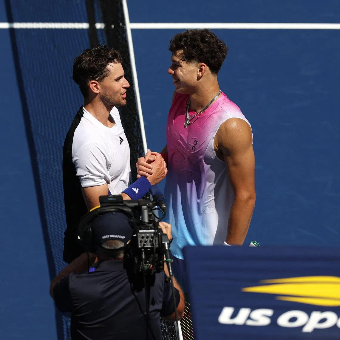 Ben Shelton (right) of the United States shakes hands with Dominic Thiem of Austria after their US Open first-round match in which Thiem lost.