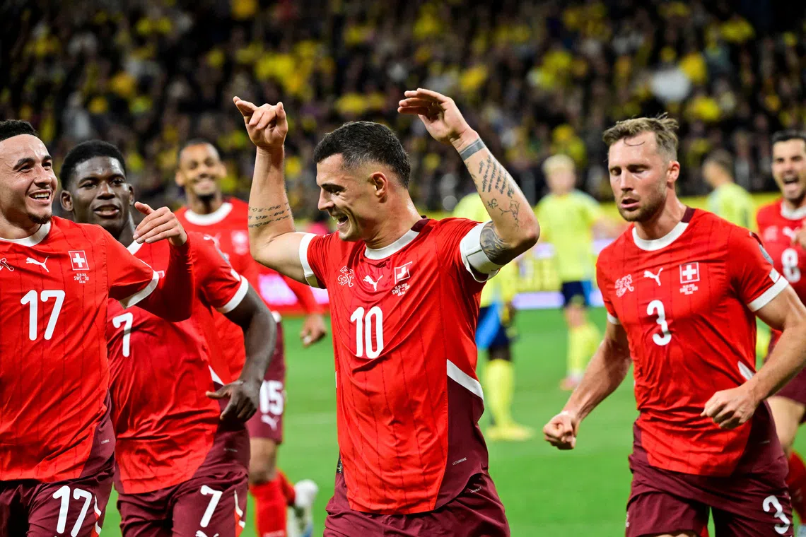 Soccer Football - FIFA World Cup - UEFA Qualifiers - Group B - Sweden v Switzerland - Strawberry Arena, Solna, Sweden - October 10, 2025 Switzerland's Granit Xhaka celebrates scoring their first goal with teammates Jonas Ekstromer/TT News Agency via REUTERS