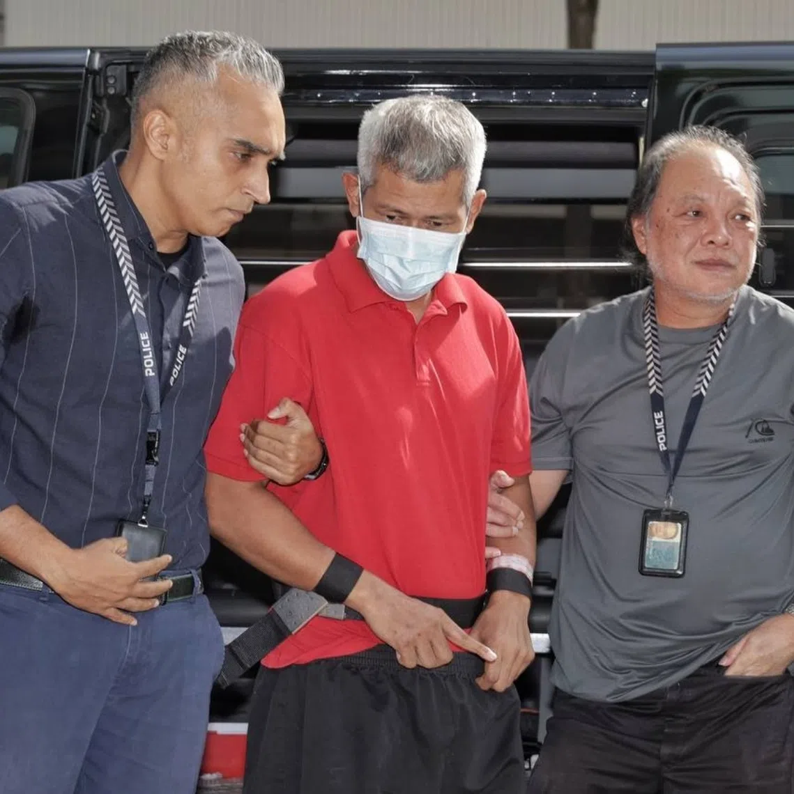 Murder suspect Affendi Yusoff being taken back to the crime scene at Block 803 Yishun Ring Road on Aug 6.