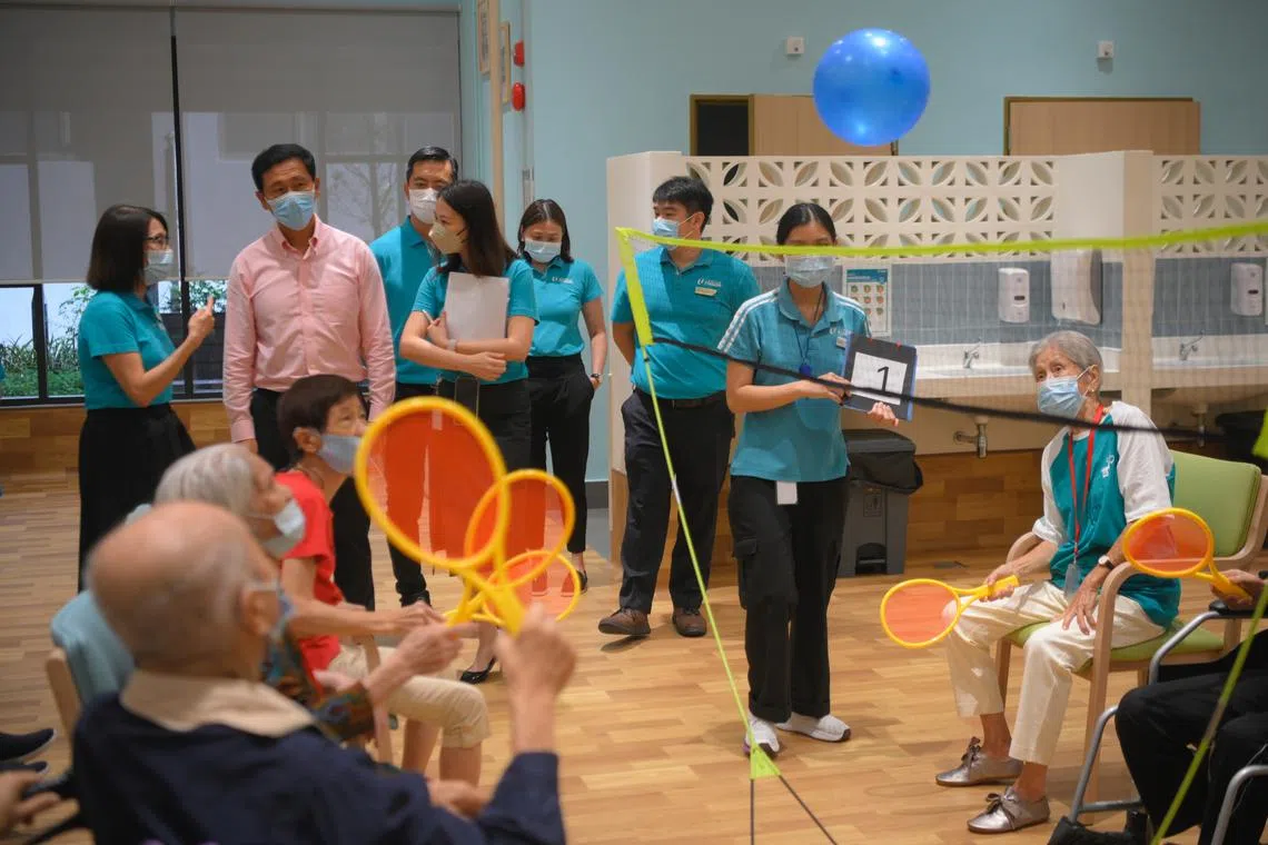 Health Minister Ong Ye Kung (in pink shirt) visits the NTUC Health Nursing Home at Jurong Spring on Jan 27, 2023.