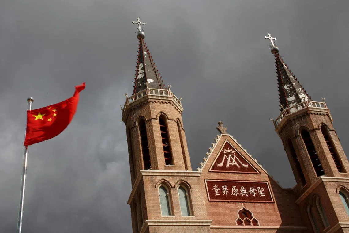 FILE PHOTO: The Chinese national flag flies in front of a Catholic underground church in the village of Huangtugang, Hebei province, China, September 30, 2018. REUTERS/Thomas Peter/File Photo