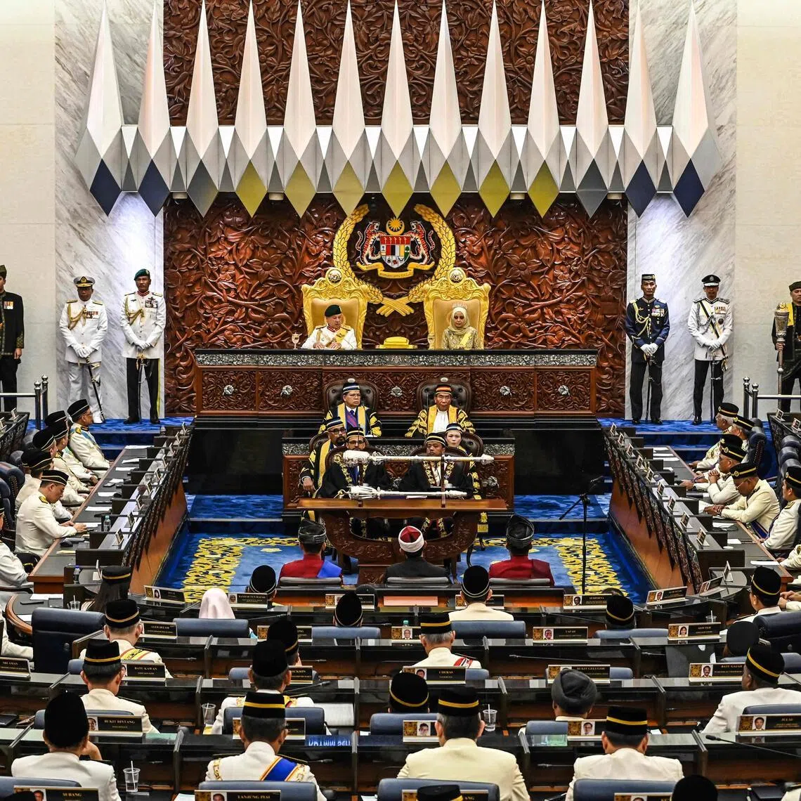 This handout photo taken and released by Malaysia's Department of Information on February 26, 2024 shows Malaysia's King Sultan Ibrahim Iskandar (top L) and Queen Raja Zarith Sofiah (top R) attending the opening of the third session of the 15th Parliament at the Parliament House in Kuala Lumpur. (Photo by Handout / MALAYSIA'S DEPARTMENT OF INFORMATION / AFP) / -----EDITORS NOTE --- RESTRICTED TO EDITORIAL USE - MANDATORY CREDIT "AFP PHOTO /  Malaysia's Department of Information " - NO MARKETING - NO ADVERTISING CAMPAIGNS - DISTRIBUTED AS A SERVICE TO CLIENTS  -