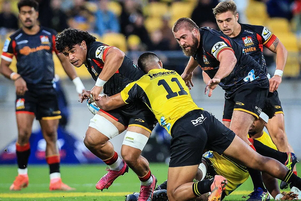 Waikato Chiefs' Wallace Sititi is tackled by Wellington Hurricanes' Salesi Rayasi during the Super Rugby Pacific semi-final at Sky Stadium in Wellington on June 15, 2024.