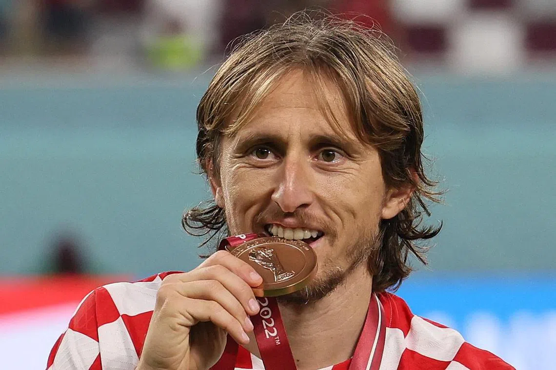 Luka Modric celebrates with his medal after Croatia won third place in the Qatar 2022 World Cup.