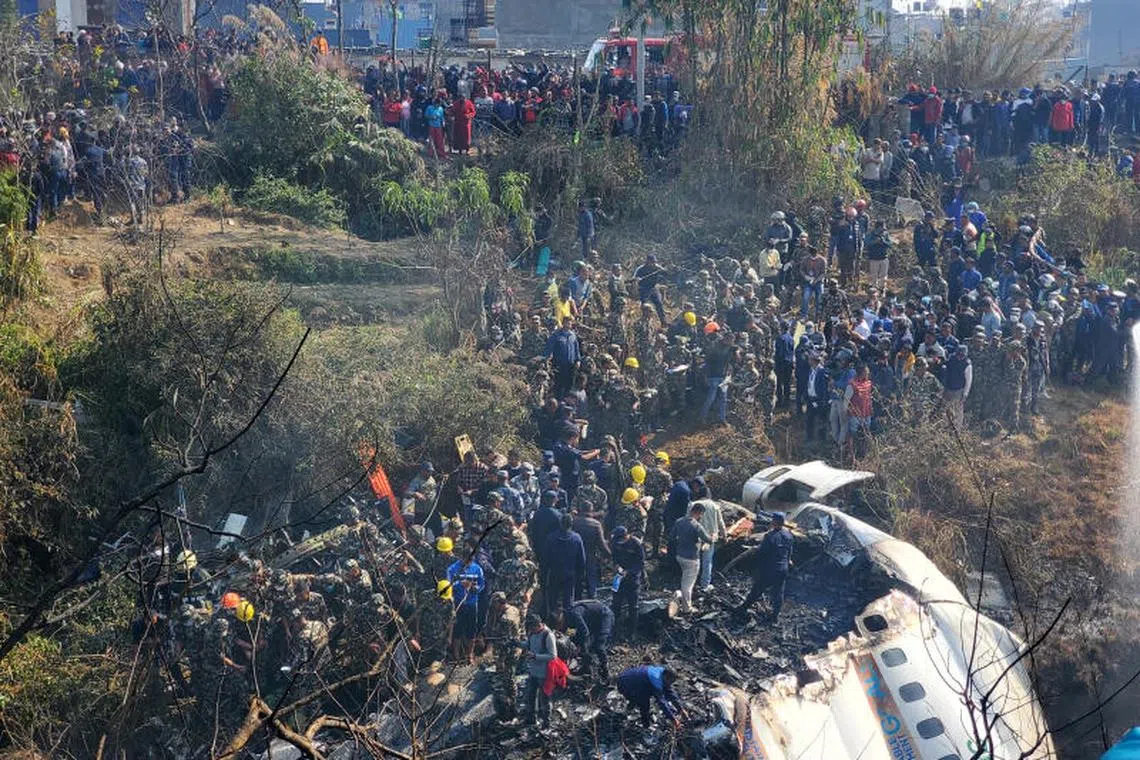 A general view of people gathered after the plane crash in Pokhara, Nepal January 15, 2023 in this picture obtained from social media. PHOTO : REUTERS