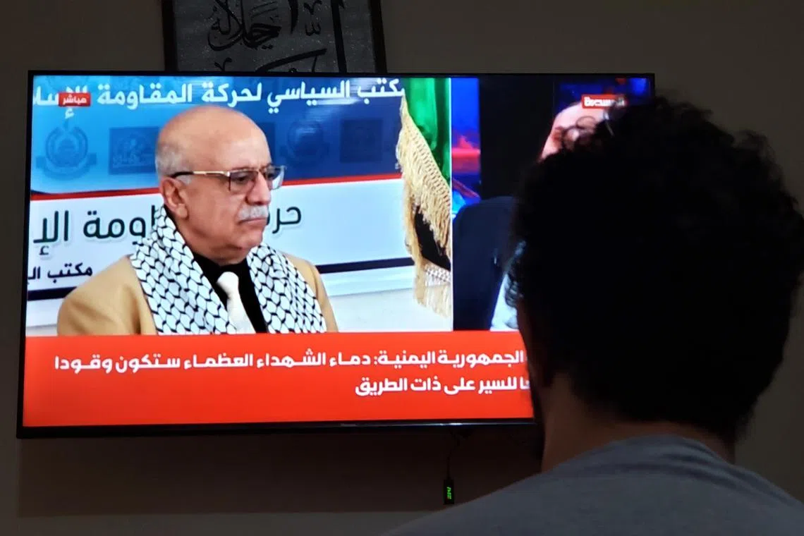 A man in Sanaa watching a TV on Aug 30 showing Houthi Prime Minister Ahmad Ghaleb al-Rahwi, who was killed in an Israeli air strike.