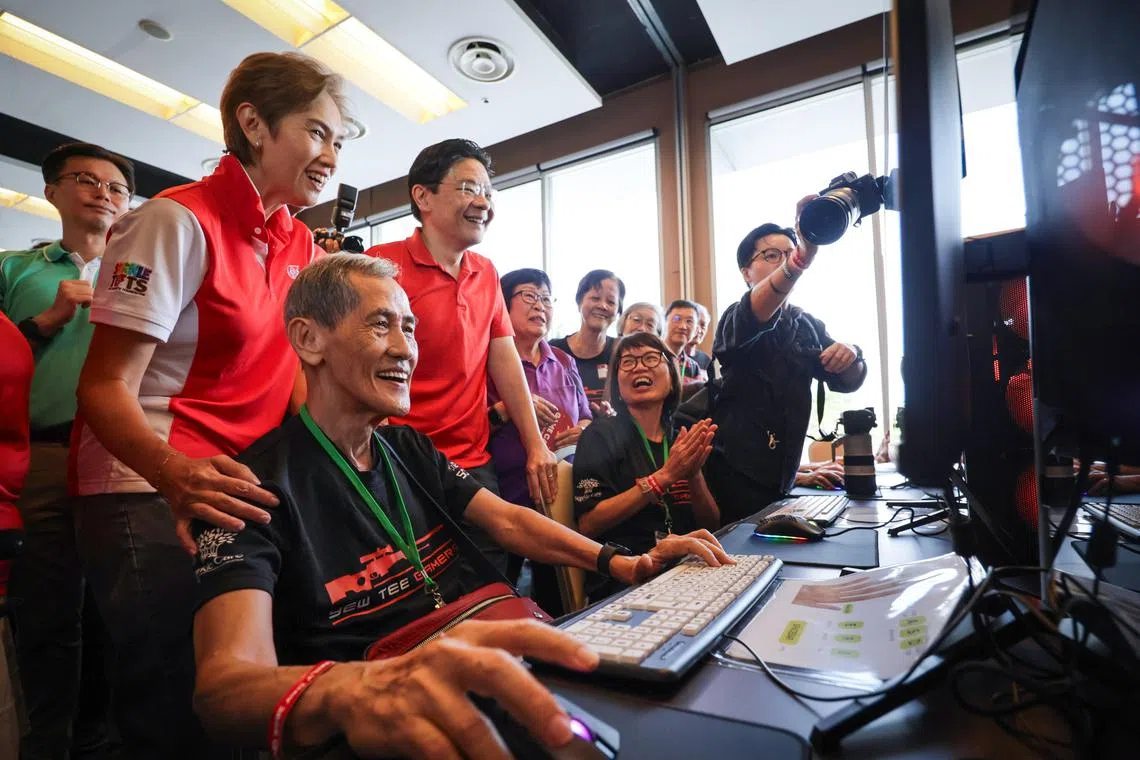 Prime Minister Lawrence Wong and Minister for Digital Development and Information Josephine Teo, with retirees Chong Hock Loo, 75, and Shirley Tan, 68, during the PCF Family Day event on July 13.
