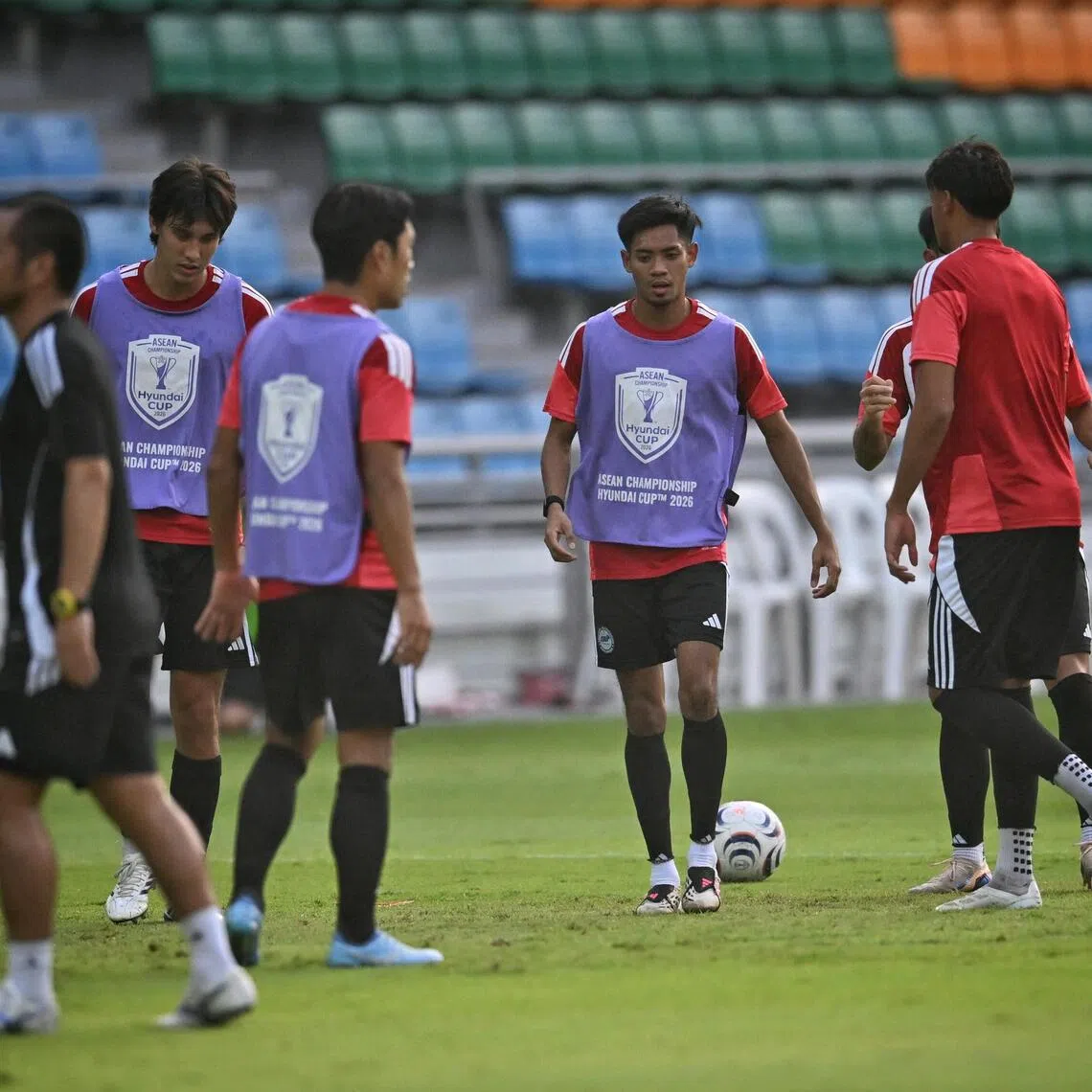 Singapore’s Shah Shahiran (centre) shows steely focus in training before the first leg of their ASEAN Championship semi-finals against Thailand.