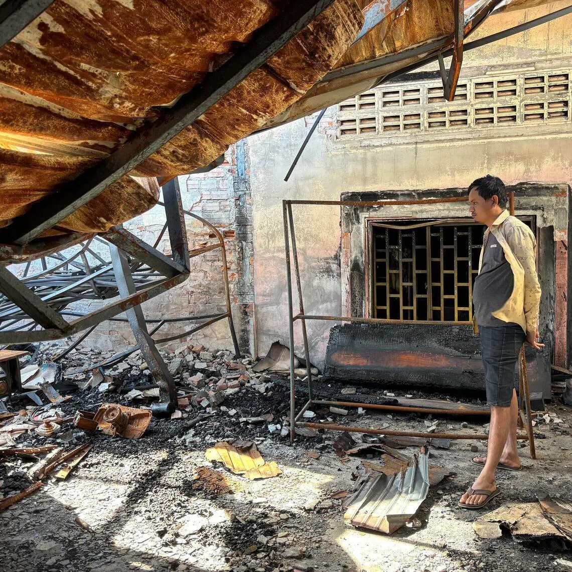 Mr Sim Srong surveys the damage of his shop in Samraong district, near the Thai border in Cambodia’s Oddar Meanchey province. His shop was damaged during the outbreak of hostilities between Cambodia and Thailand.
